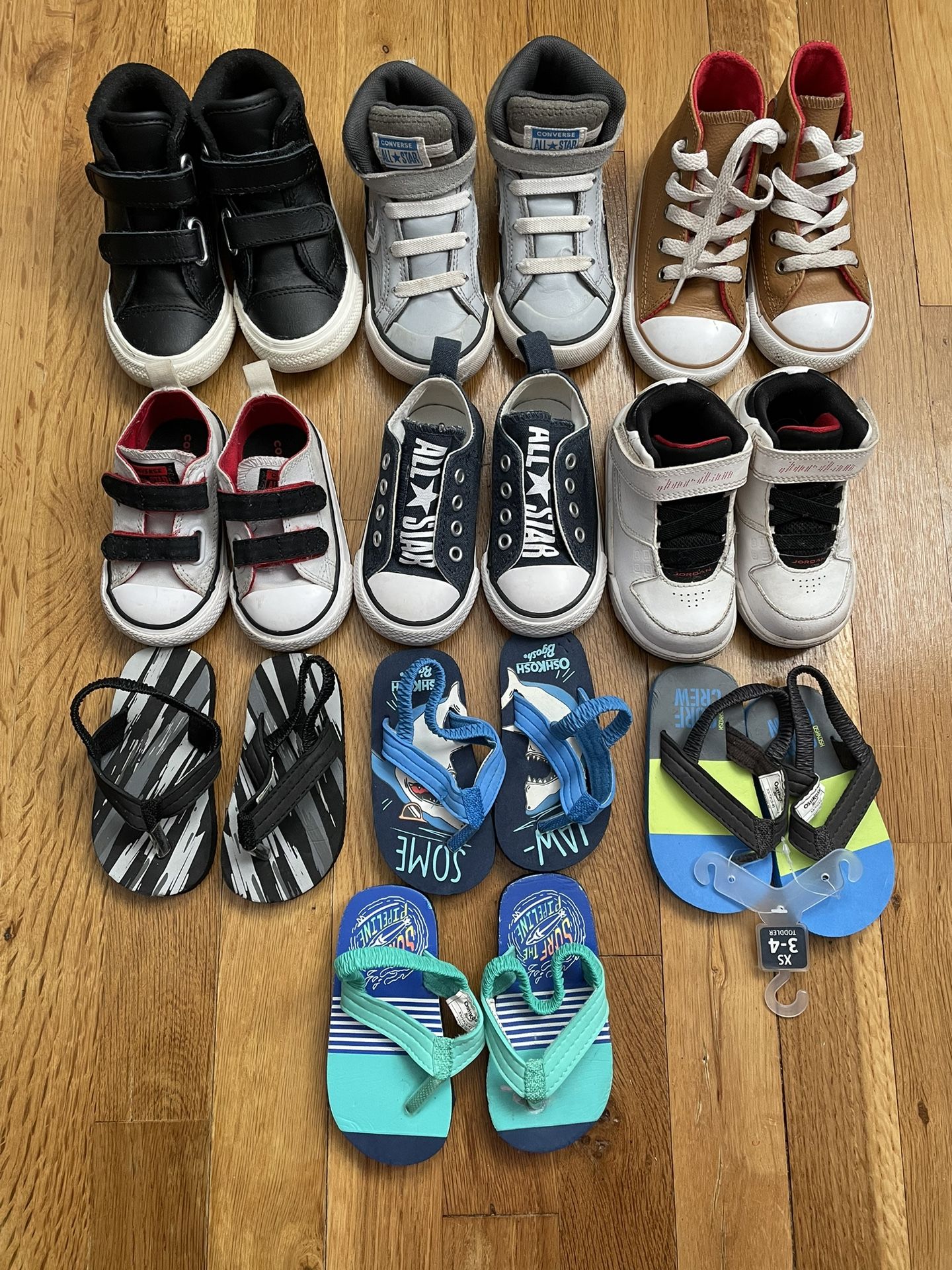 10 Pairs of Toddlers Shoes and flip flops. Flip flops size 3-4, Gray and black converse size 4, Blue all star converse size 5. All other shoes size 6.