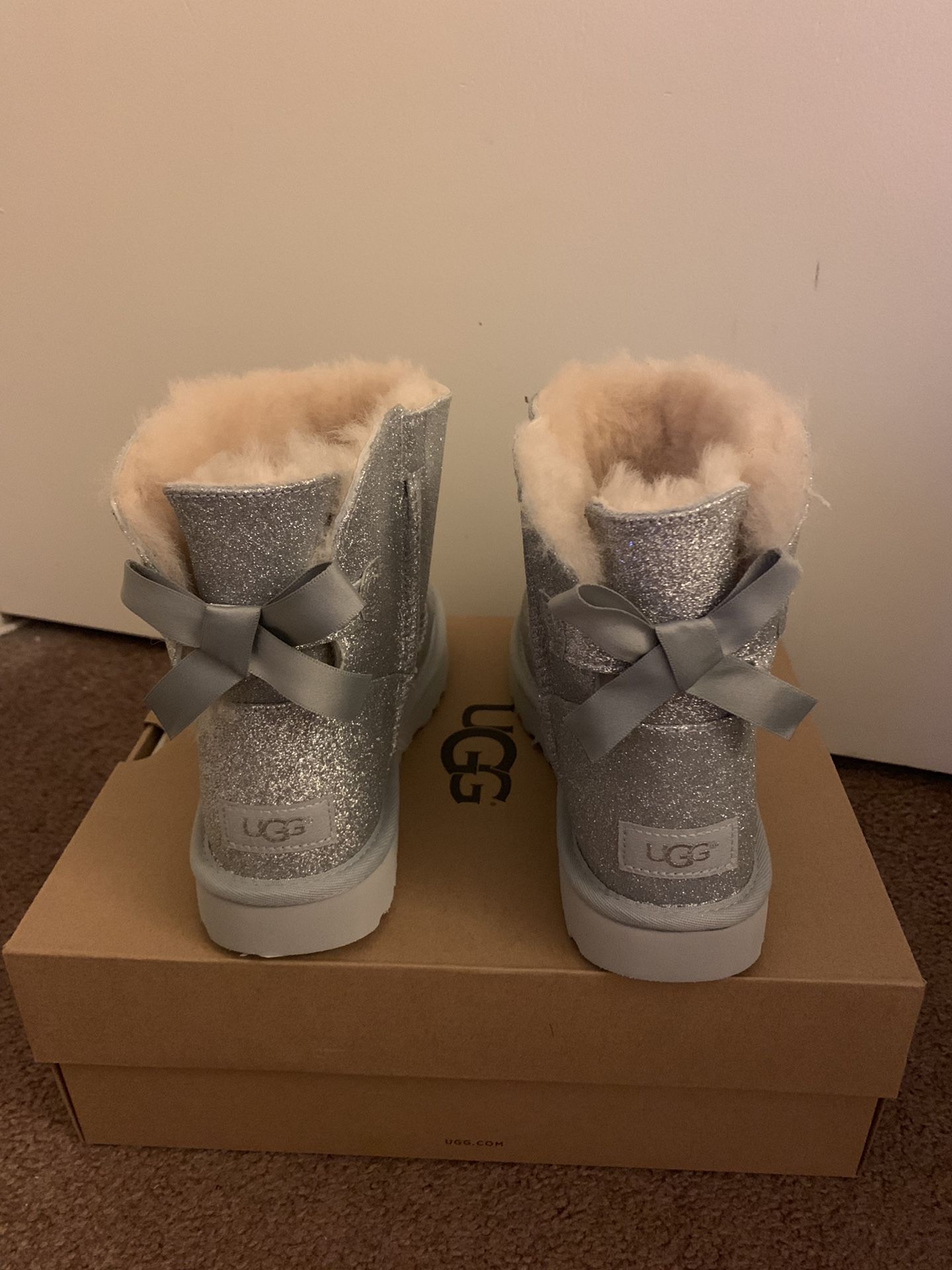 100% Authentic Brand New in Box UGG Mini Bailey Bow Sparkle Black Boots / Women size 9 / Color: silver