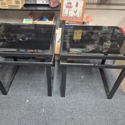 set of black glass coffee and end tables with metal frames. 