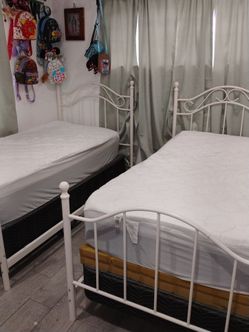 White metal twin beds