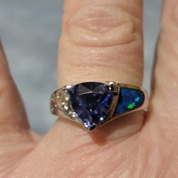 Beautiful Solid 925 Silver That Is Also Rodium Plated With A Natural Blue Sapphire And White AAA White Cz's On One Side And Fire Blue Opal Size 7. 