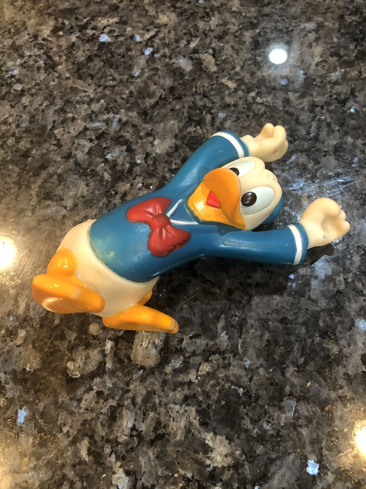 Vintage Disney Donald Duck Soft Rubber Toy Figure Arms Up Stretched Over His Head. Very old. Size 5 inches long. Preowned good condition.