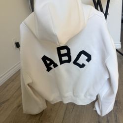 Short hooded zip-up sweatshirt with embroidered letters, slightly stained