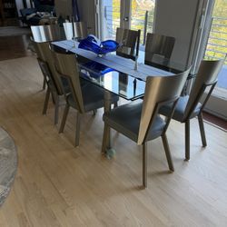 Dining Room Glass Table  and  (8) Stainless Steel/leather Chairs