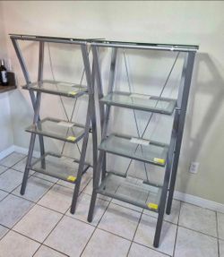 Two 4 TIER GLASS SHELVES. NO CHIPS OR SCRATCHES. 
MOVING....MUST SELL!
60" TALL ● 28" WIDE ● 
Glass Shelves are 21" x 13.5"
$120 OBO!