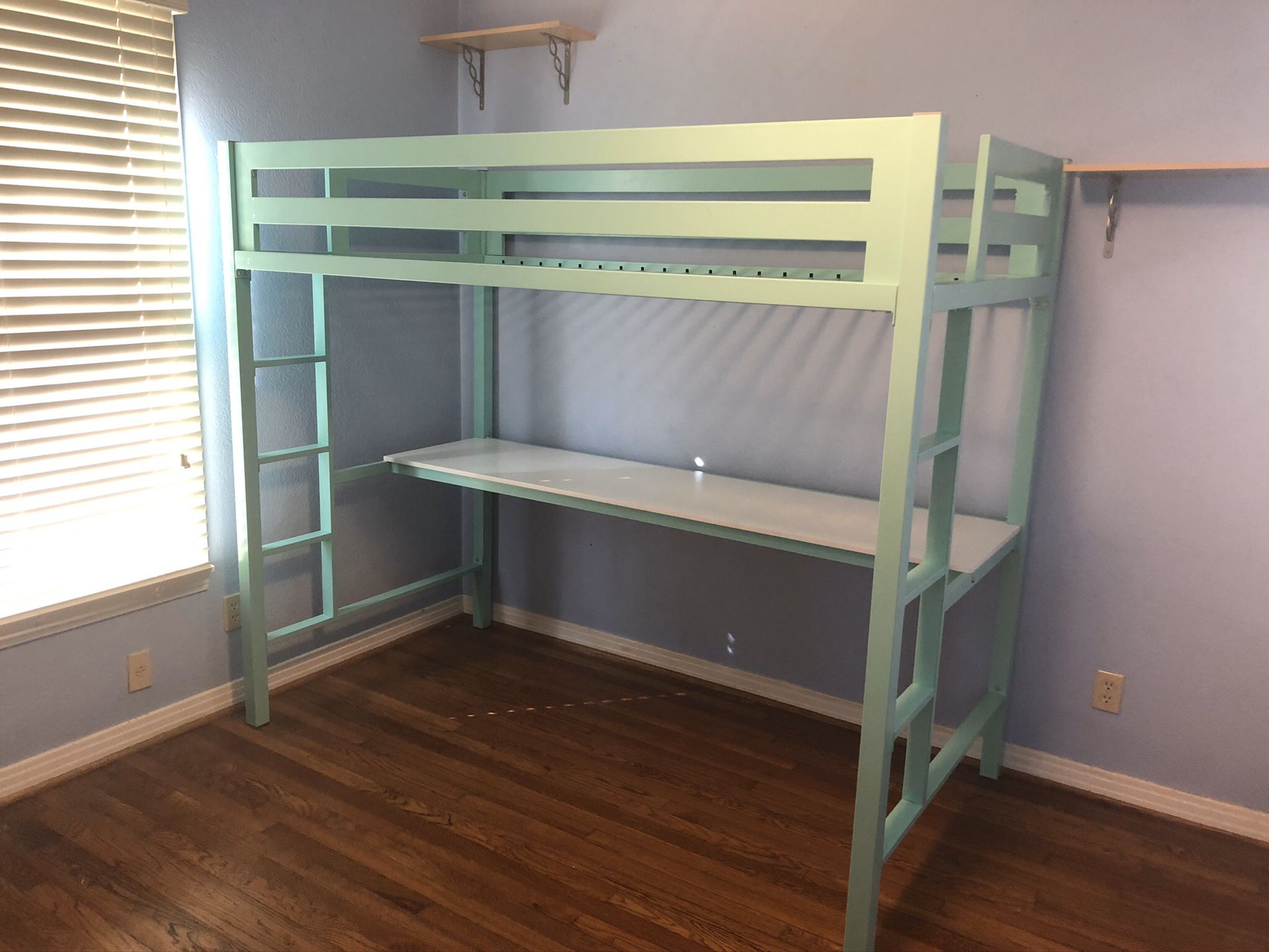 Mint green lofted twin bed with desk below