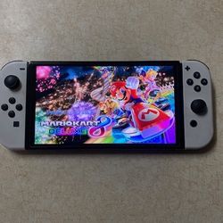 NINTENDO SWITCH OLED with 120 SWITCH GAMES IN LUDED