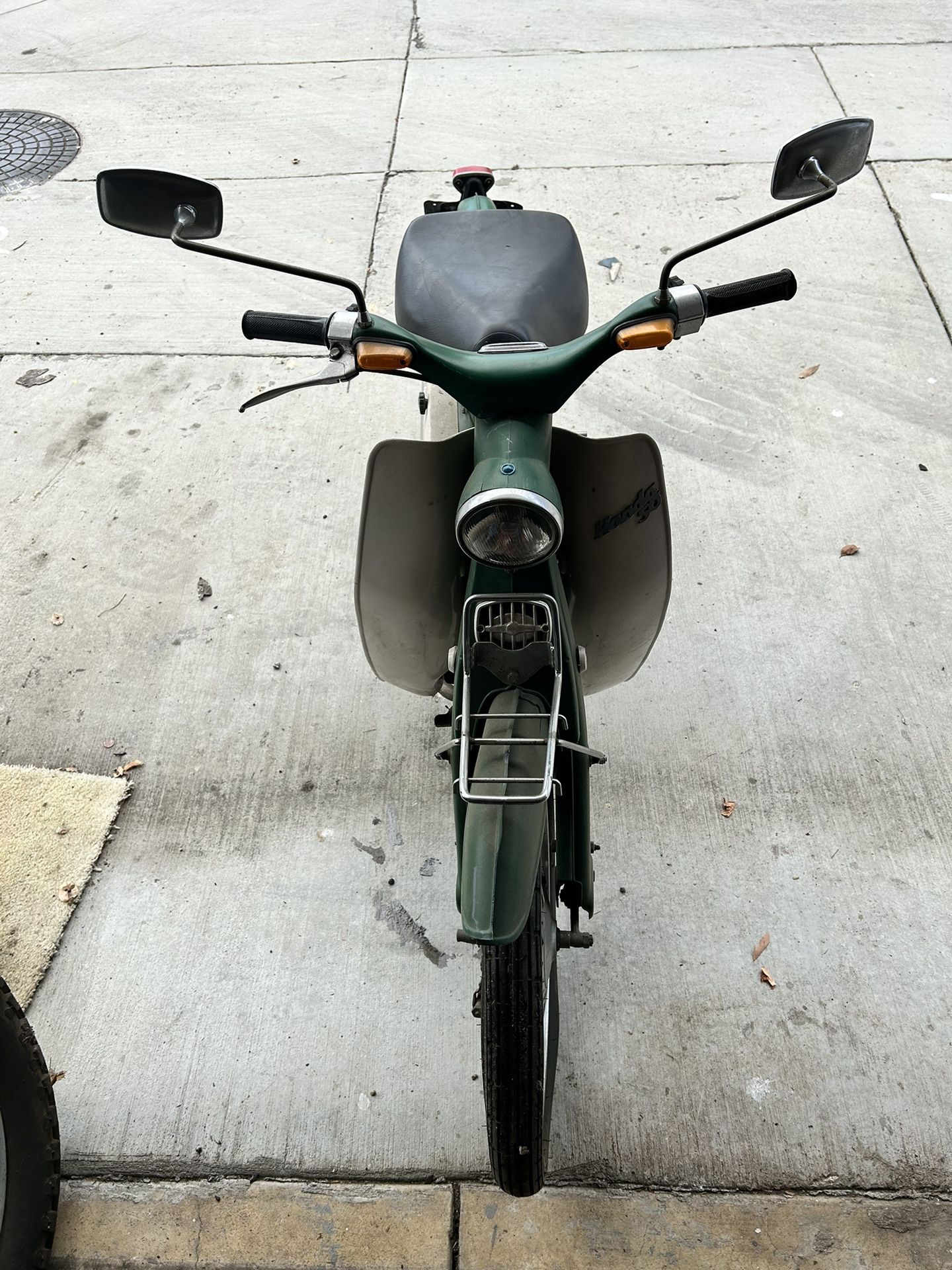 Green and white 1961 Honda Cub 65