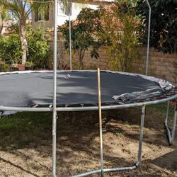 Trampoline  Big Size.  Disassembled. Needs New Net. 