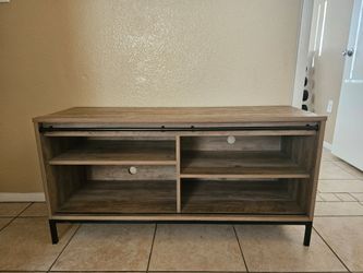 Modern light brown TV stand with black accents