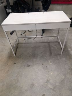 White desk with electrical outlets
