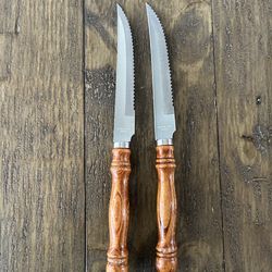 Vintage 1970s stainless steel serrated knives with wood handles