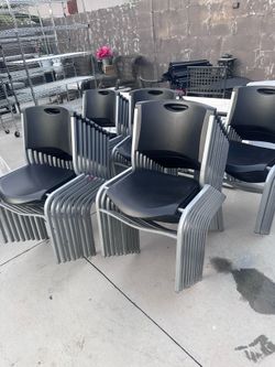 39 black plastic and metal stack chairs