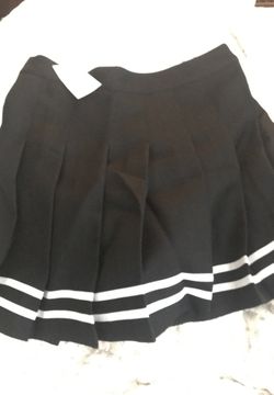Super cute and flirty H&M brand pleated black skirt with white ribbon detailing.