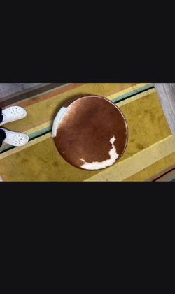 Brown cowhide round pouf