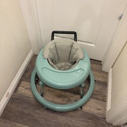 Used like new adjustable heights baby walker on wheels