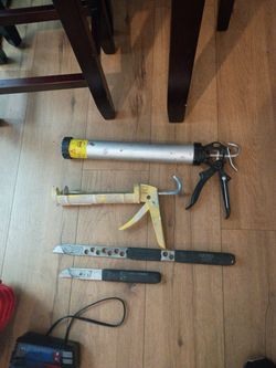 Two caulking guns and two utility knives right