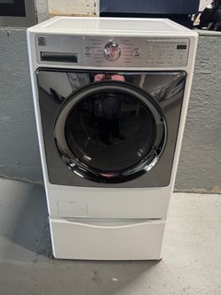 White Kenmore washing machine, 27 inches wide and 38 inches high; includes a receipt for a 90-day warranty.