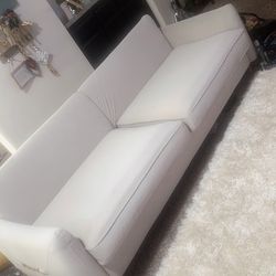 Light beige sofa with gold accents