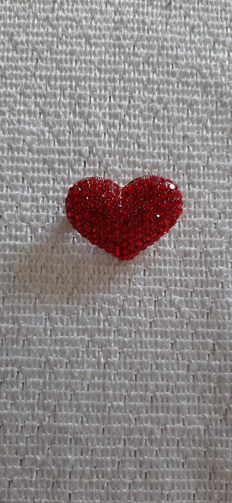 Red heart-shaped rhinestone brooch.