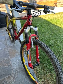 Bicycle mountain bike Vintage Gary Fisher Paragon mountain bike with a red and yellow aluminum frame. This hardtail mountain bike has a RockShox Judy 