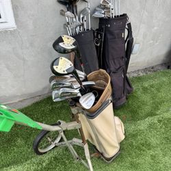 A Bunch Of Golf Clubs And Bags