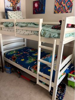 White bunk bed with mattresses