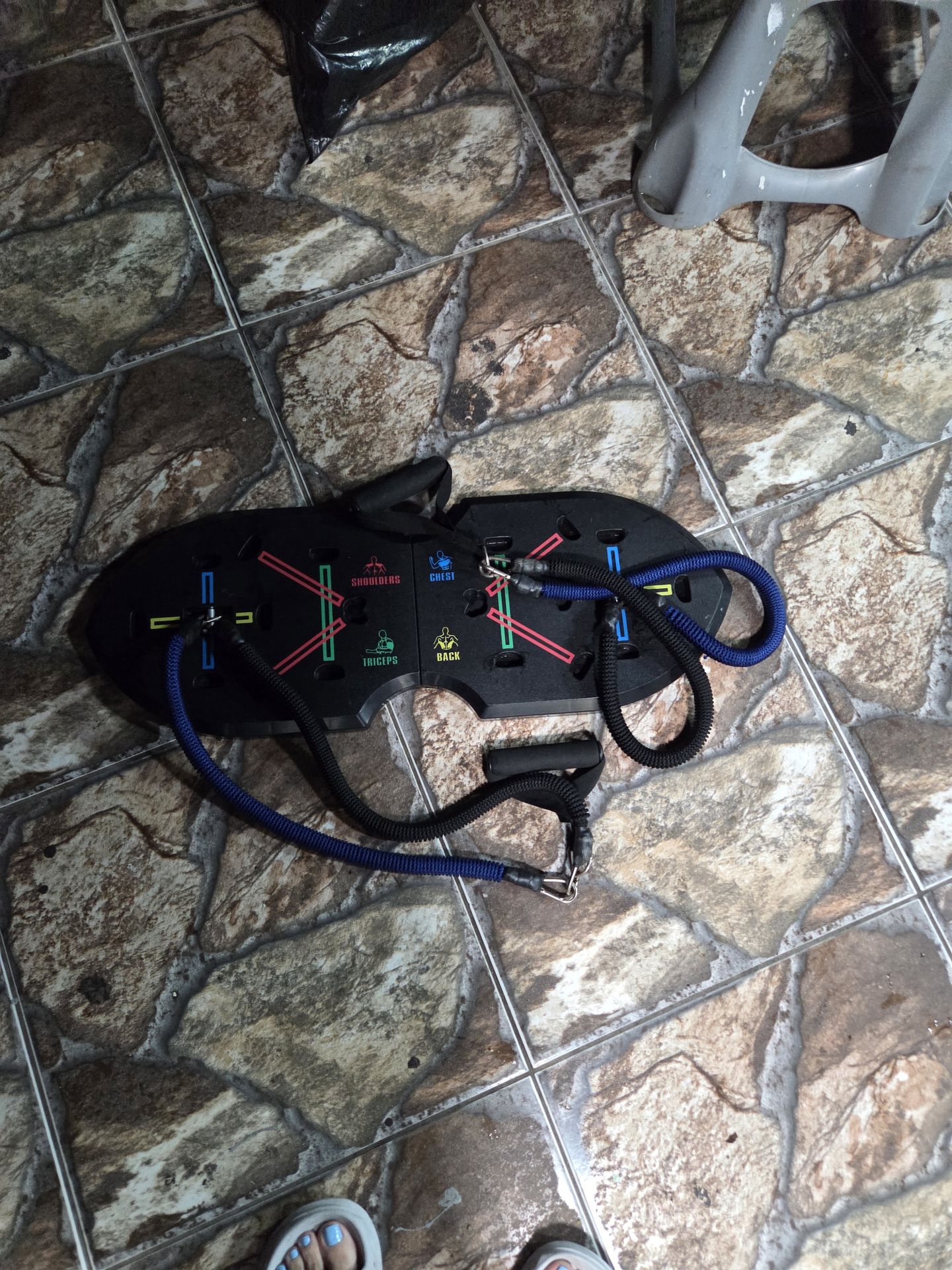 multi-functional push-up board with resistance bands, designed for home strength training.