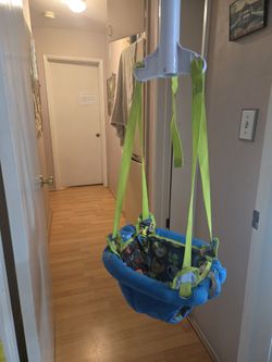 Evenflo ExerSaucer Blue and Green Baby Doorway Jumper. Baby Jumper.