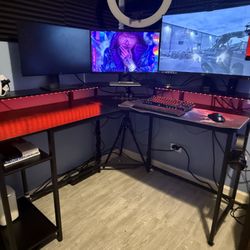 L-Shaped desk w/ LED lights and power strip attached.