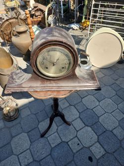 This item resembles a vintage mantel clock, often called a Napoleon Hat shape due to its curved design.