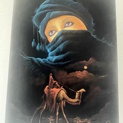 MIDDLE EASTERN  BLACK VELVET PAINTING MEASUREMENTS 26” X 18” OF A BEAUTIFUL BEDOUIN WOMEN AND  MAN SITTING ON A CAMEL DREAMING OF LOVE