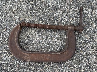 This is a heavy-duty, rusty C-clamp, a common hand tool used for holding workpieces securely during woodworking