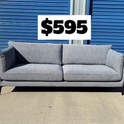 Brand New. Mid Century Modern Sofa. Grey/blue. Retails For $1400. 2 Available. $595 Each