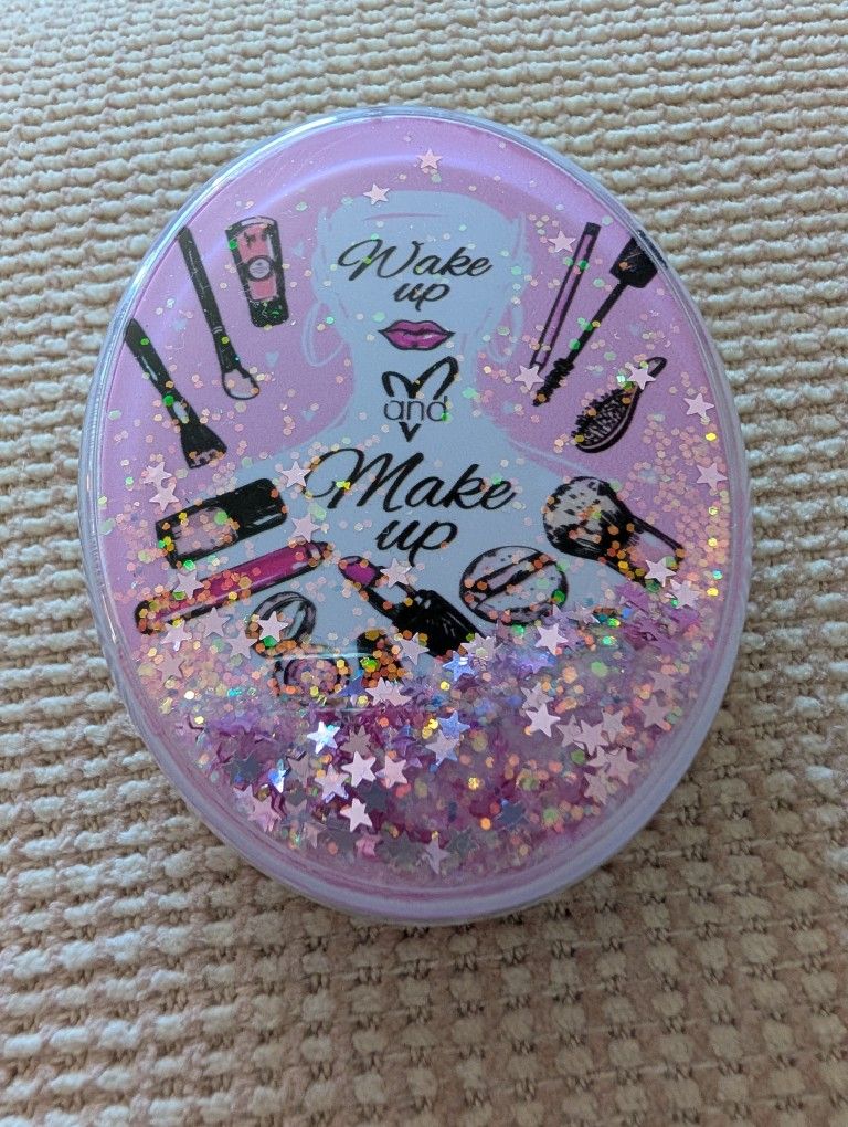 (NEW) OVAL COMPACT MIRROR WITH FLOWING, SPARKLING GLITTER AND A "WAKE UP AND MAKE UP" DESIGN