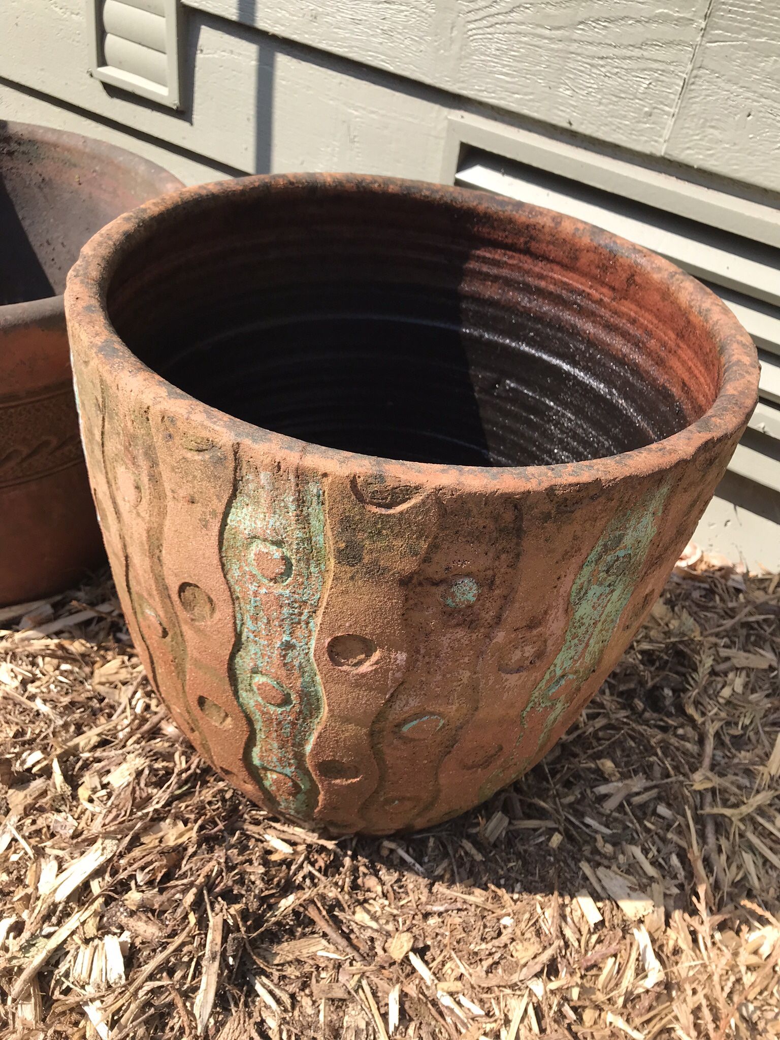 Clay Pot And A Metal Art Work For The Yard