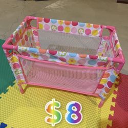 Pink and multicoloured polka dot playpen