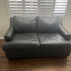 Gray leather loveseat