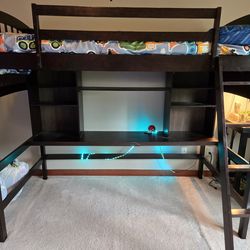 Twin bunk bed frame with shelves and mattress