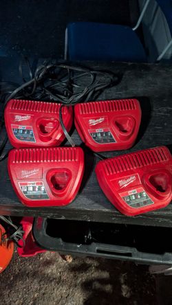 4 Milwaukee battery chargers and bag