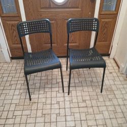 Set Of Stackable Black Plastic And Metal Chairs 