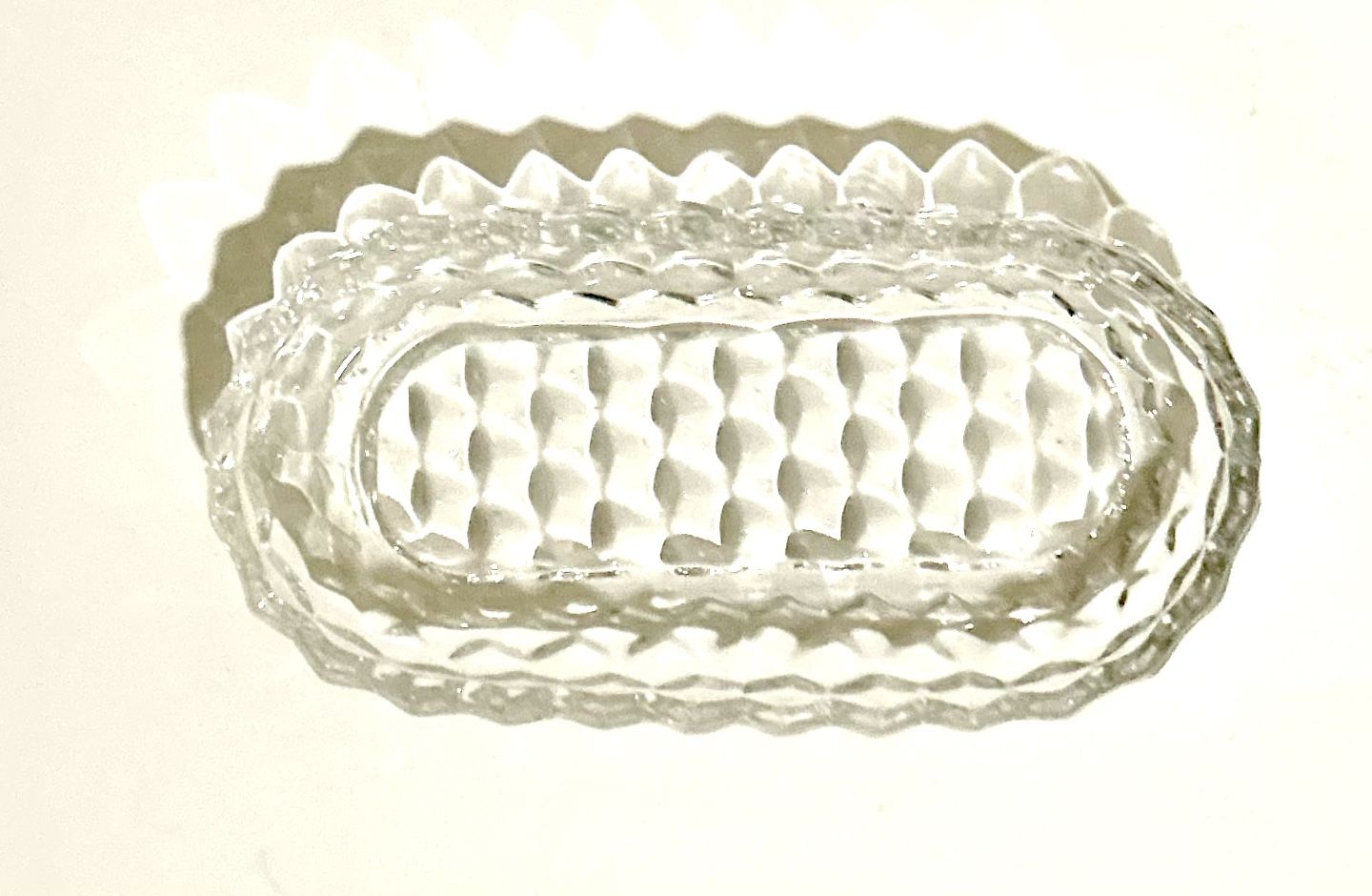 glass dish is a Fostoria American pattern oval celery or relish dish. This clear, heavy pressed glass pattern features a distinctive cube or diamond