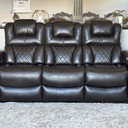 Dark brown leather sofas.