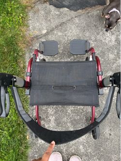 Red vive walker with foot rest