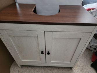 Pedestal sink cabinet.