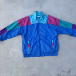 Blue windbreaker with multi-coloured accents size medium 