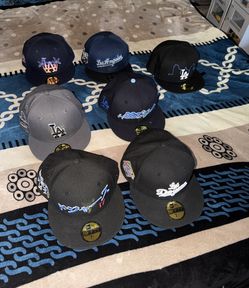7 new era authentic hats some from hat club most were purchased at Lids all size 7 1/2 all LA divers selling the lot of 7 for 200.00 over 500 in hats