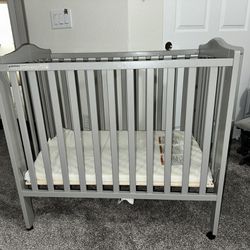 Delta Children Folding Portable Mini Baby Crib with 1.5-inch Mattress