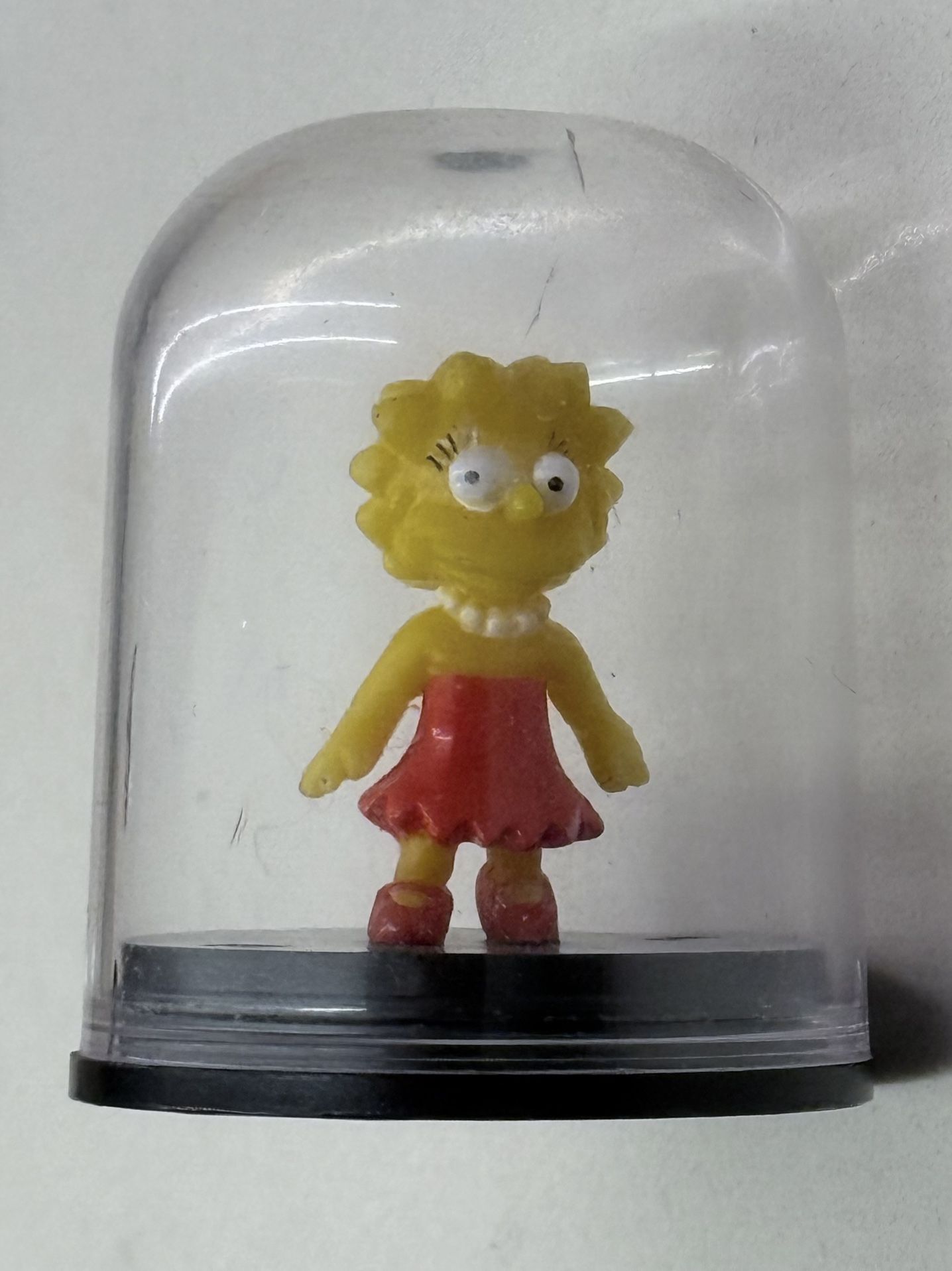 Lisa Simpson figurine encased in a clear dome