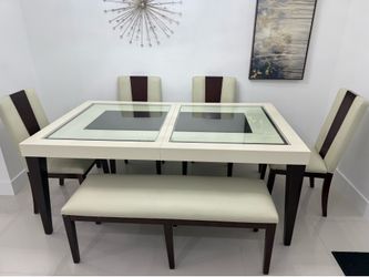 Table with chairs and a bench. Four chairs and one bench.